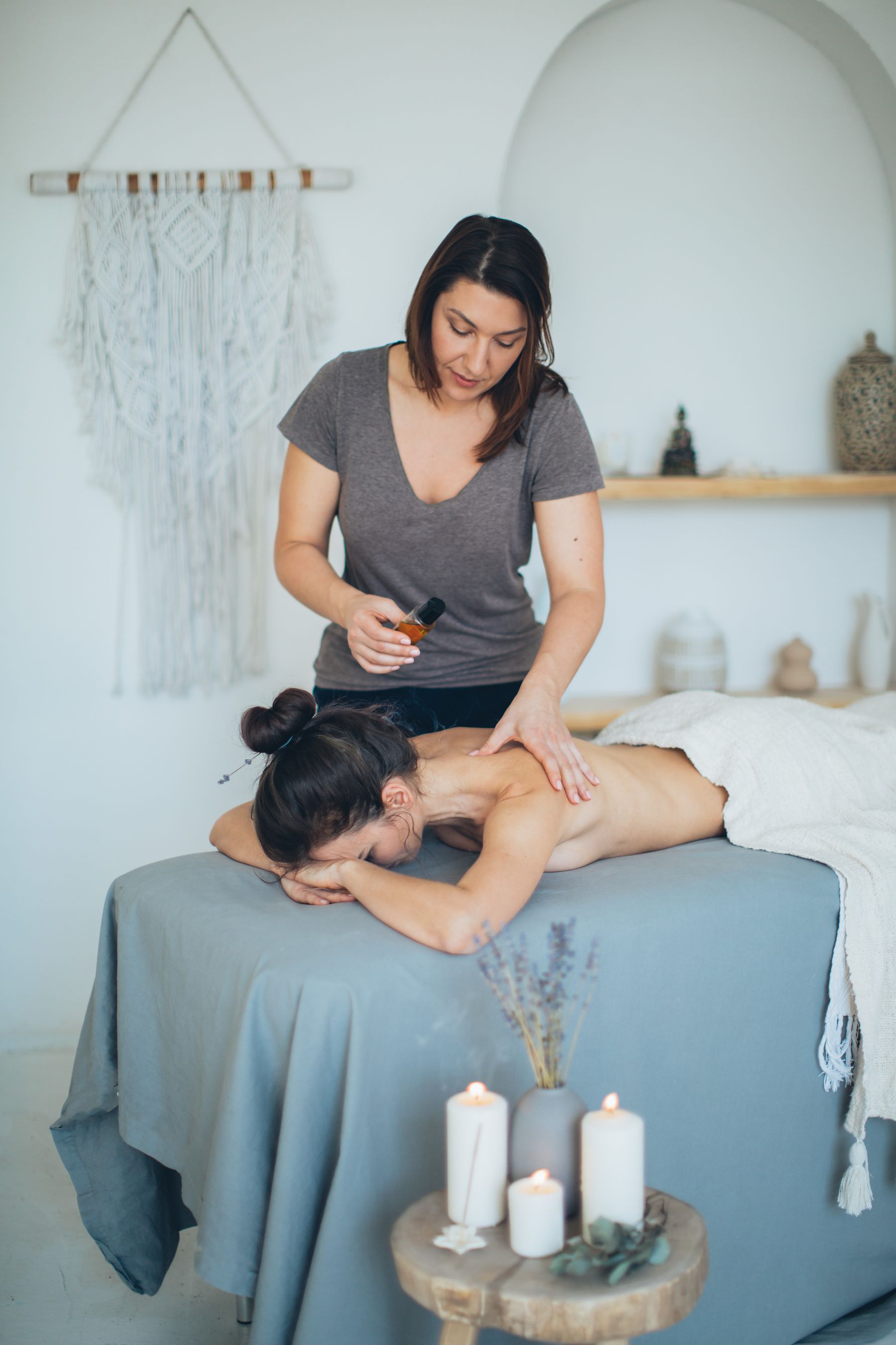 Spa massage with candles and essentials