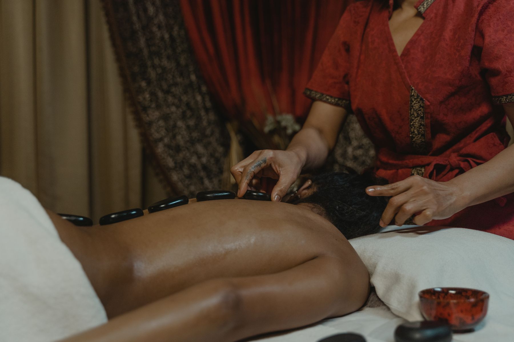 Hot stone massage in a warm spa room