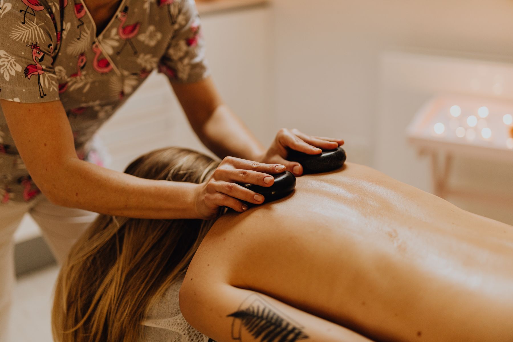 Therapist placing warm stones during a massage